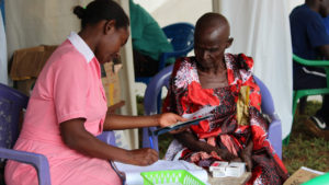 Nurses working with a patient at Nana Health Clinic Mobile clinic, World Malaria Day 2021